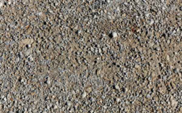 Crushed stone mixed with fines, the kind used as granular sub-base, close-up — stock photo