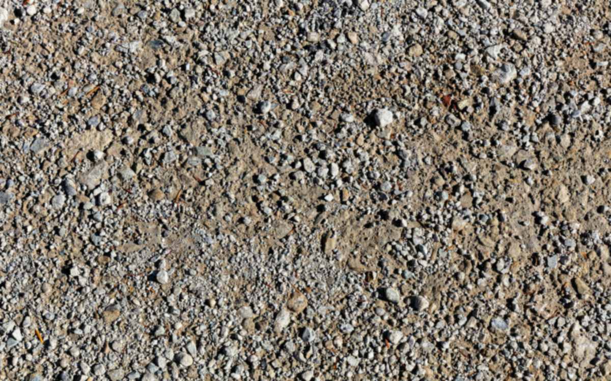 Crushed stone mixed with fines, the kind used as granular sub-base, close-up — stock photo