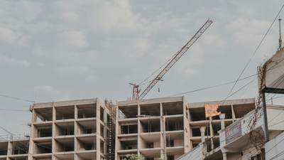 Concrete frame of a building under construction with a tower crane