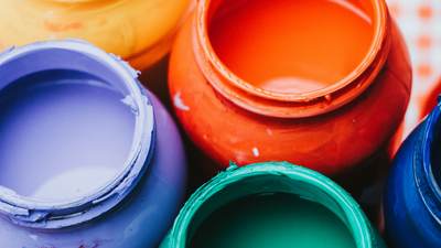 Open tins of coloured paint, close-up