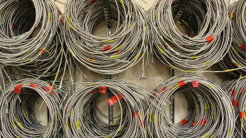 Coils of electrical wire hanging on a wall